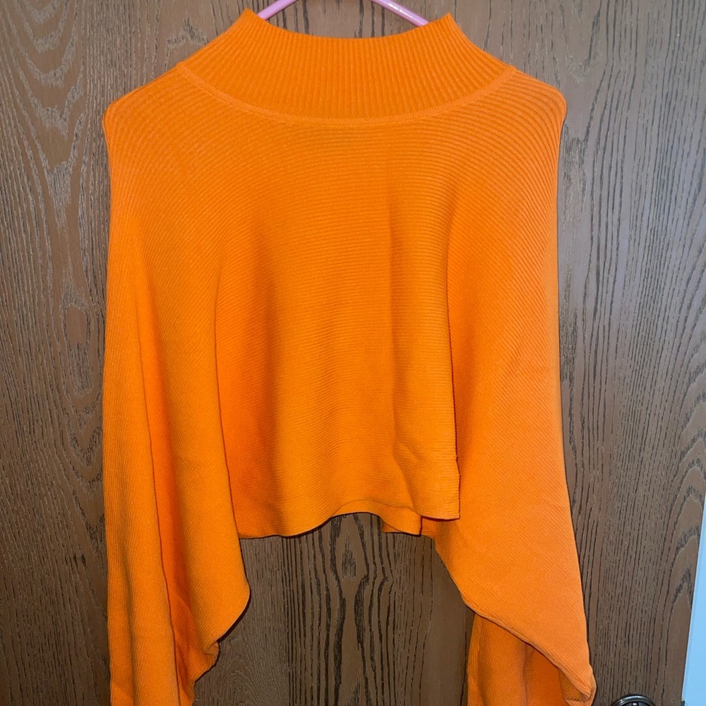 Cropped orange turtle neck with cute sleeves. Barely worn